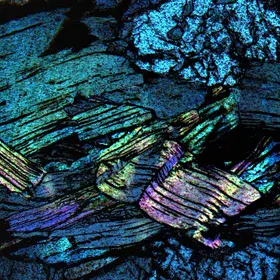 Folded muscovite layers in XPL view from the Norra Kärr complex, Sweden.
